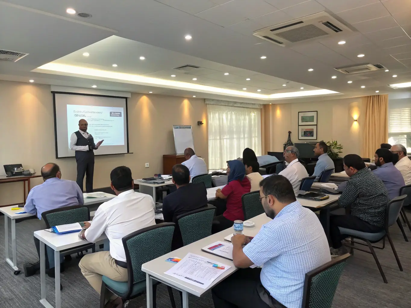A modern training room with professionals receiving SAP and AI certifications, certificates in hand, and a digital display showing over 1, 200 professionals trained by JGM Academy.